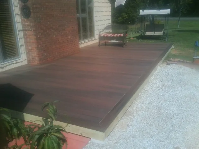 Freshly stained wood deck built against a brick home in Courtland